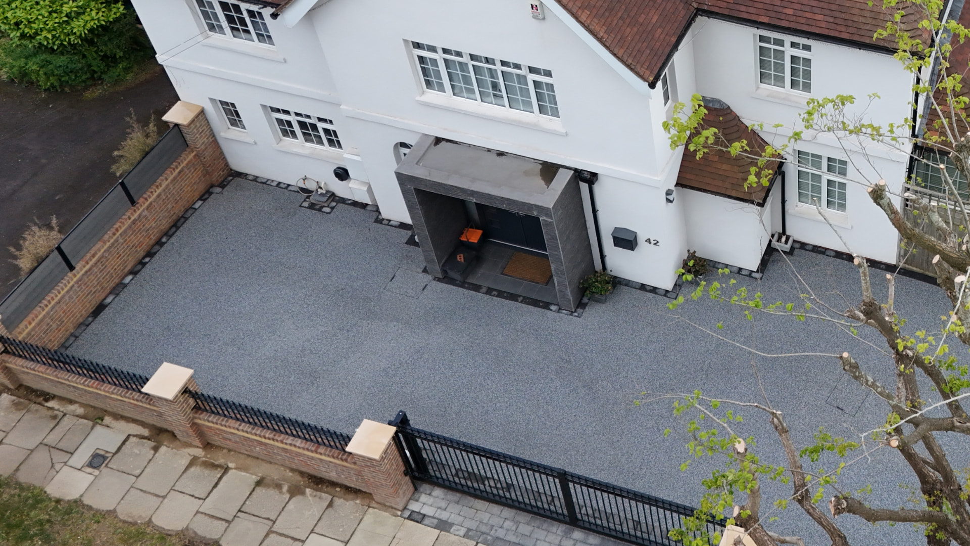 Aerial view of a Sussex home with a newly laid tarmac driveway